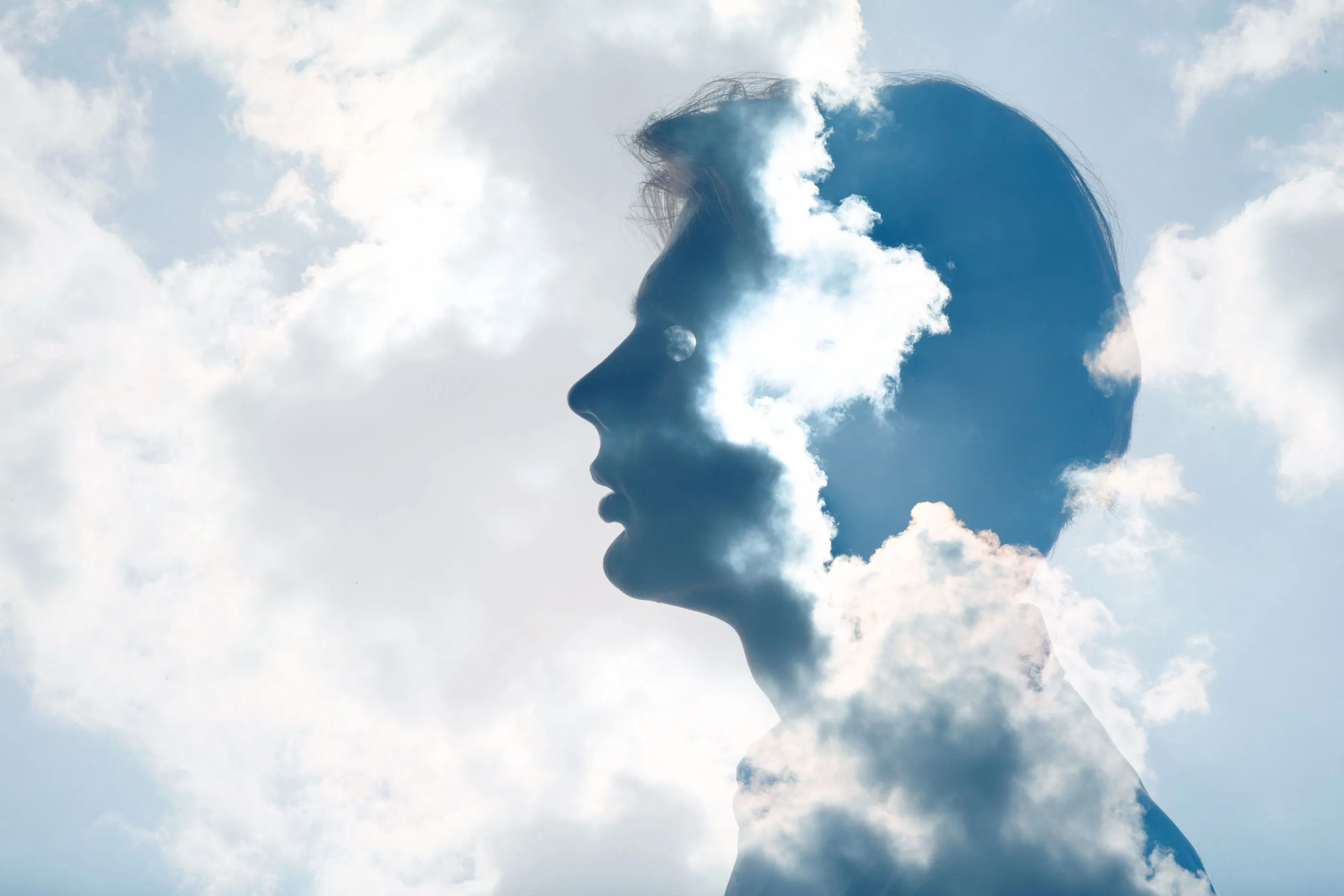 an image of a persons head in clouds