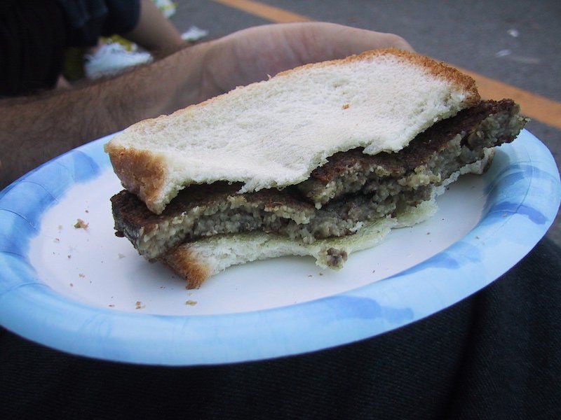 Picture of delicious Delaware delicacy, the Scrapple Sandwich, on a blue rimmed white paper plate